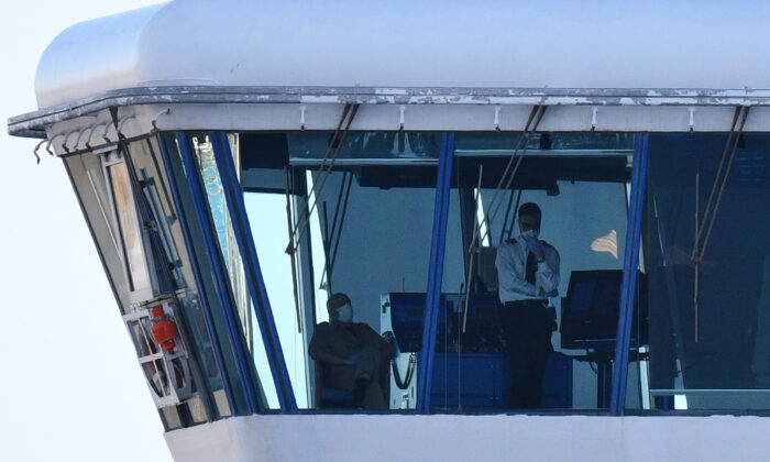 Crew members aboard the Diamond Princess cruise ship are seen at its wheelhouse at the Daikoku Pier Cruise Terminal in Yokohama port on Feb 27, 2020. (Kazuhiro Nogi/AFP via Getty Images)