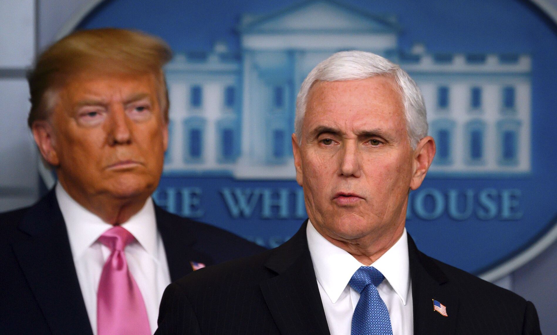 President Donald Trump (L) looks on as Vice President Mike Pence