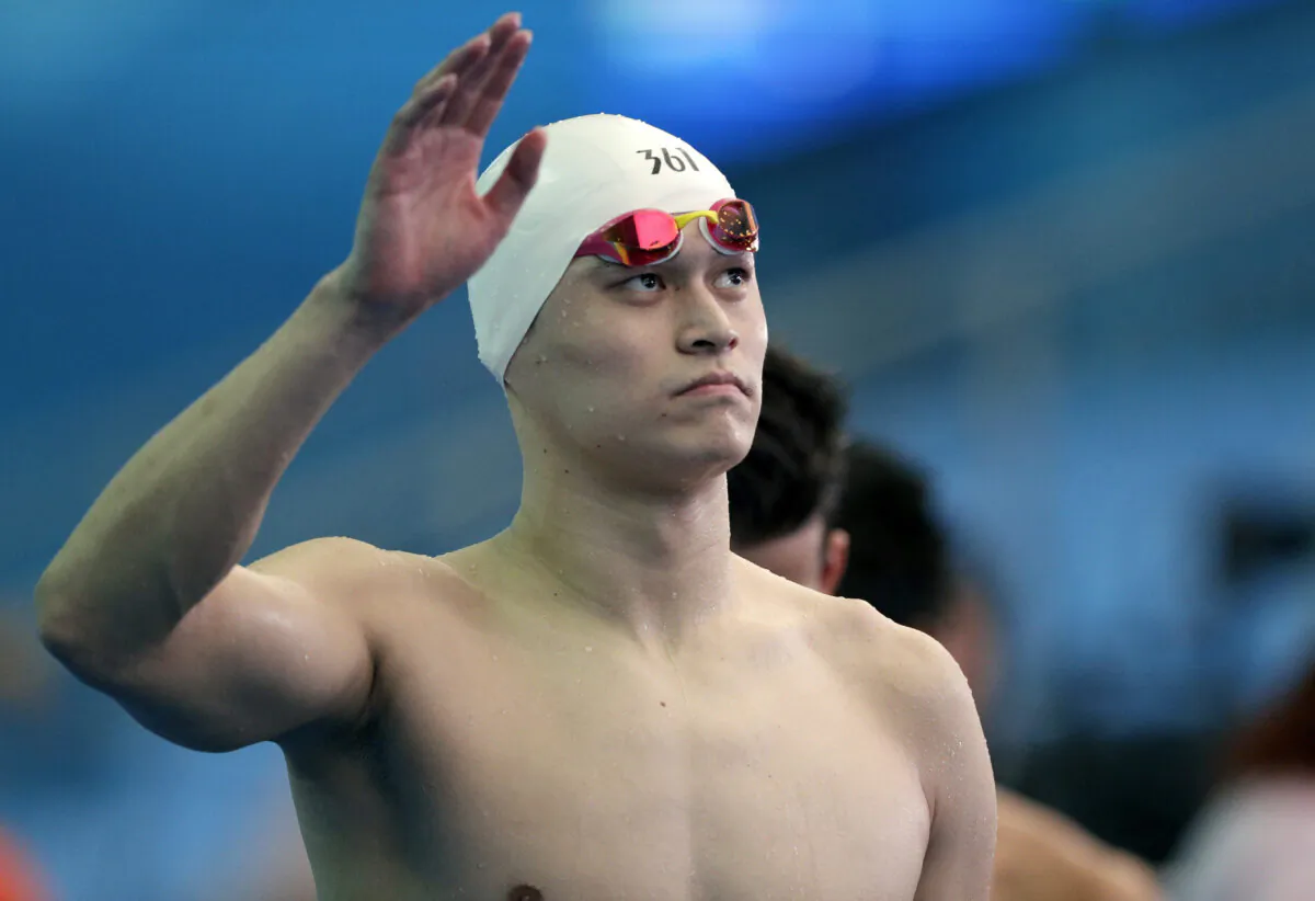 China's Sun Yang waves as he leaves the pool deck following the men's 4x200m freestyle relay heats at the World Swimming Championships in Gwangju, South Korea, on July 26, 2019. (Mark Schiefelbein/AP Photo)