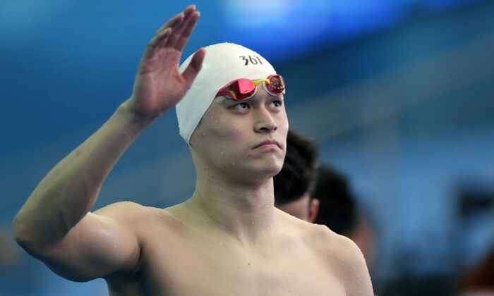 China's Sun Yang waves as he leaves the pool deck following the men's 4x200m freestyle relay heats at the World Swimming Championships in Gwangju, South Korea, on July 26, 2019. (Mark Schiefelbein/AP Photo)