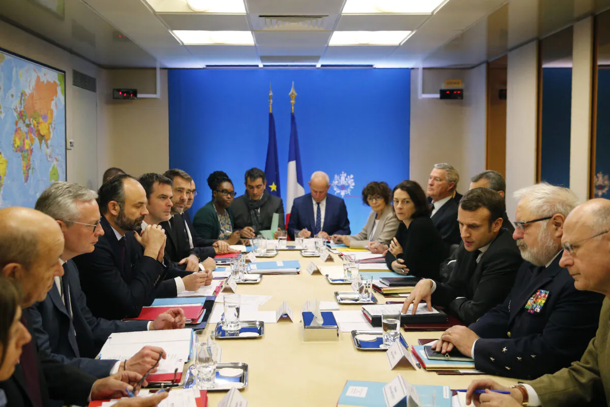 French President Emmanuel Macron, third right, chairs a meeting concerning the COVID-19 situation in France, at the Elysee Palace in Paris on Feb. 29, 2020. (Jean-Claude Coutausse, Pool via AP)