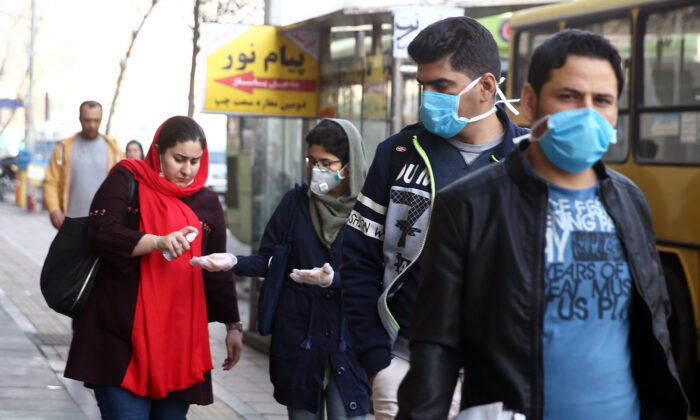 Iranian people wear protective masks to prevent spreading the coronavirus, in Tehran, Iran, on Feb. 29, 2020. (West Asia News Agency)/Nazanin Tabatabaee via Reuters)