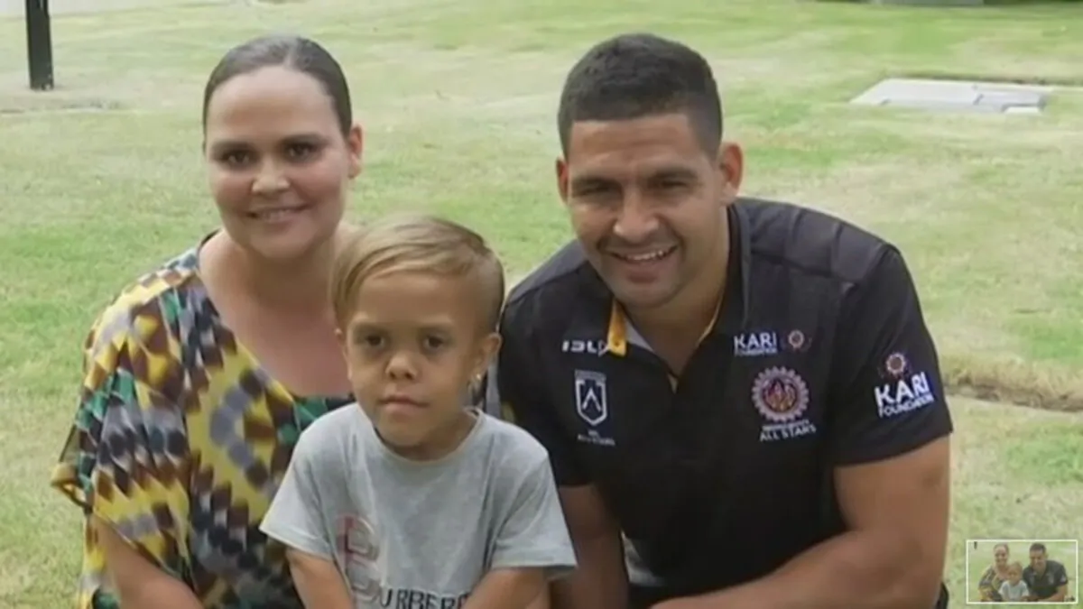 In this photo taken from video provided by Australian Broadcasting Corporation, Quaden Bayles, center, his mother, Yarraka Bayles, and Cody Walker, a professional rugby league player, pose together Friday, Feb. 21, 2020, in Gold Coast, Australia (Australian Broadcasting Corporation/Associated Press)
