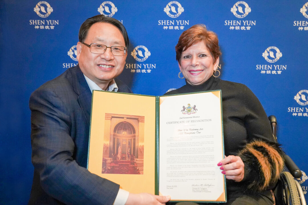 Pennsylvania State Senator Christine Tartaglione (R) bestows a certificate of recognition on the local organizers of Shen Yun Performing Arts, the Greater Philadelphia Falun Dafa Association, at the Merriam Theater, where she attended the performance, on Feb. 28, 2020. (NTD Television)