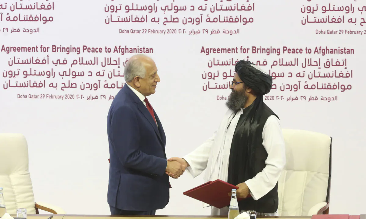 U.S. peace envoy Zalmay Khalilzad (L), and Mullah Abdul Ghani Baradar, the Taliban group's top political leader shake hands after signing a peace agreement between Taliban and U.S. officials in Doha, Qatar, on Feb. 29, 2020. (Hussein Sayed/AP Photo)