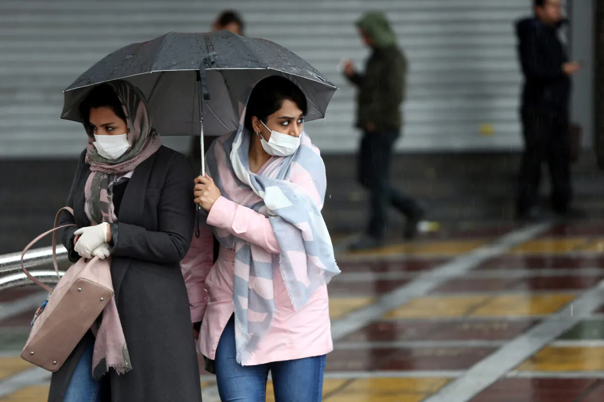 Iranian women wear protective masks to prevent contracting coronavirus, as they walk in the street in Tehran, Iran, on Feb. 25, 2020. (West Asia News Agency/Nazanin Tabatabaee via Reuters)