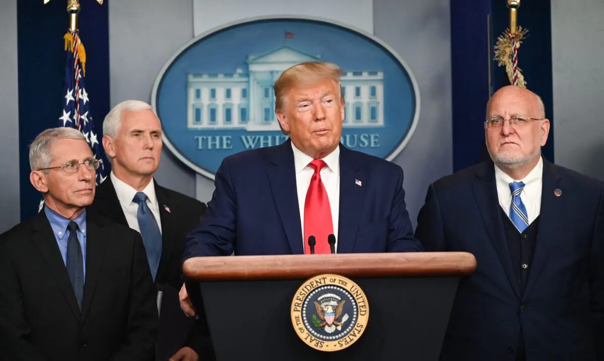 President Donald Trump speaks as Director of the National Institute of Allergy and Infectious Diseases at the National Institutes of Health as Anthony Fauci (L), Vice President Mike Pence (2L), and Director of the Centers for Disease Control and Prevention Robert Redfield (R) look on during a press conference on the COVID-19 coronavirus outbreak at the White House in Washington on Feb. 29, 2020. (Roberto Schmidt/AFP) 