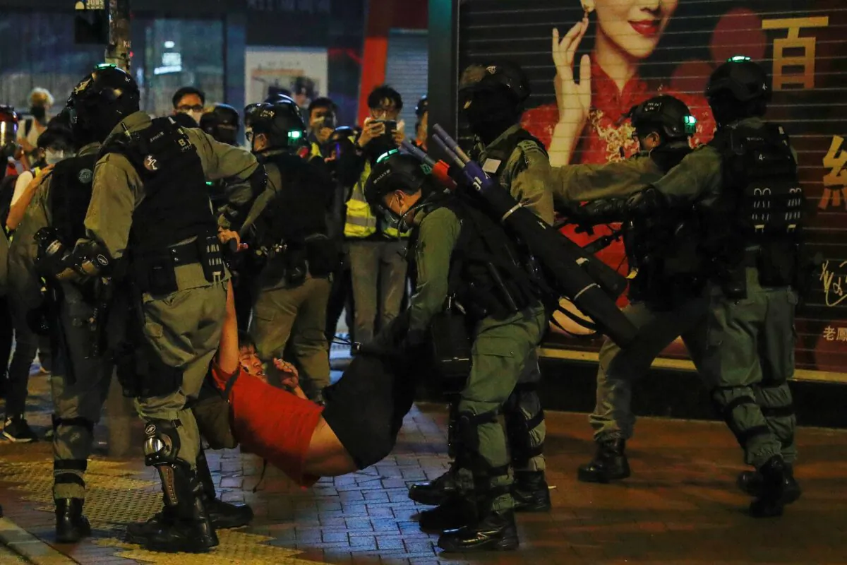 Riot police detain a protester in Mong Kok, Hong Kong, on Feb. 28, 2020. (Tyrone Siu/Reuters)