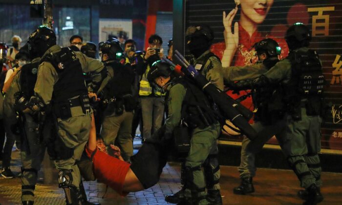 Riot police detain a protester in Mong Kok, Hong Kong, on Feb. 28, 2020. (Tyrone Siu/Reuters)