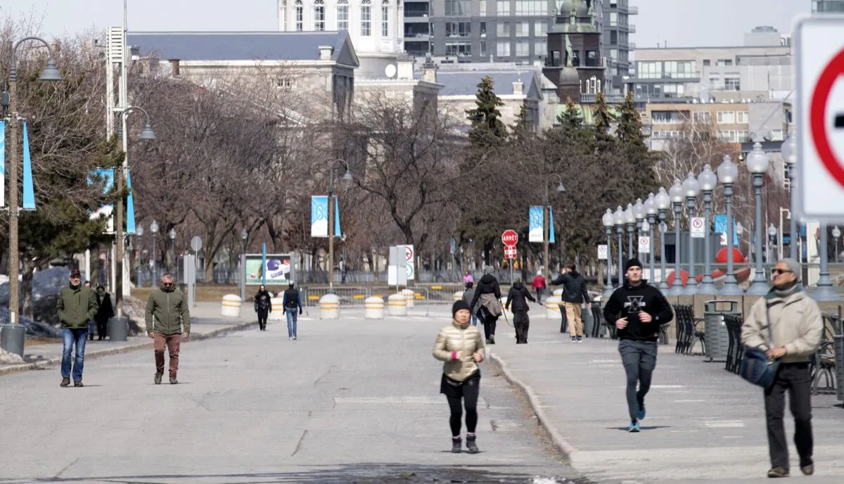 People are shown out walking in the Old Port of Montreal on March 25, 2020, as COVID-19 cases rise in Canada and around the world. (The Canadian Press/Graham Hughes)