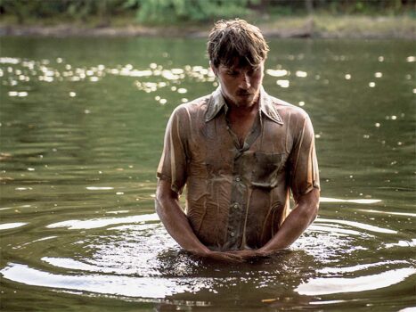 man in water praying