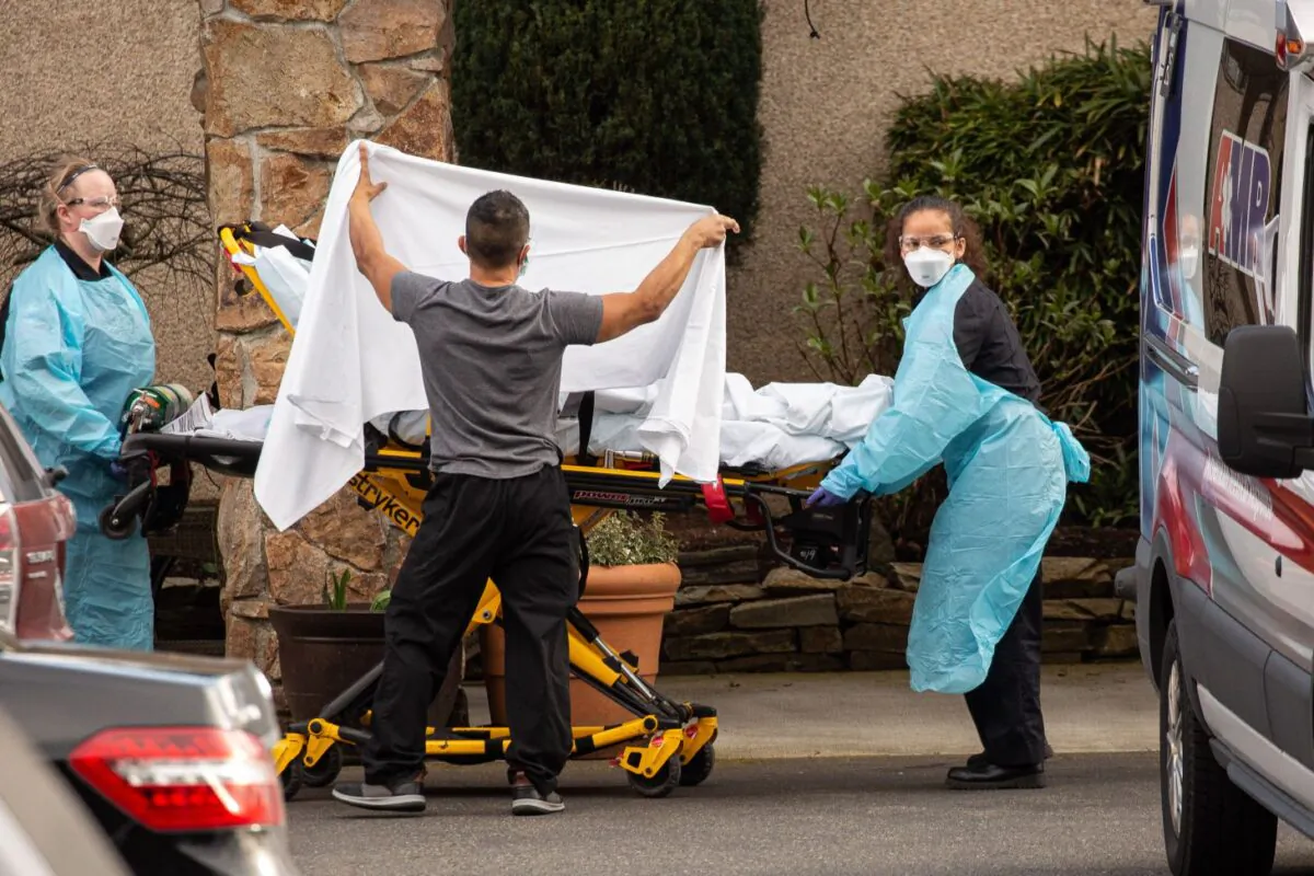 Healthcare workers transport a patient on a stretcher into an ambulance at Life Care Center of Kirkland in Kirkland, Washington, on Feb. 29, 2020. (David Ryder/Getty Images)