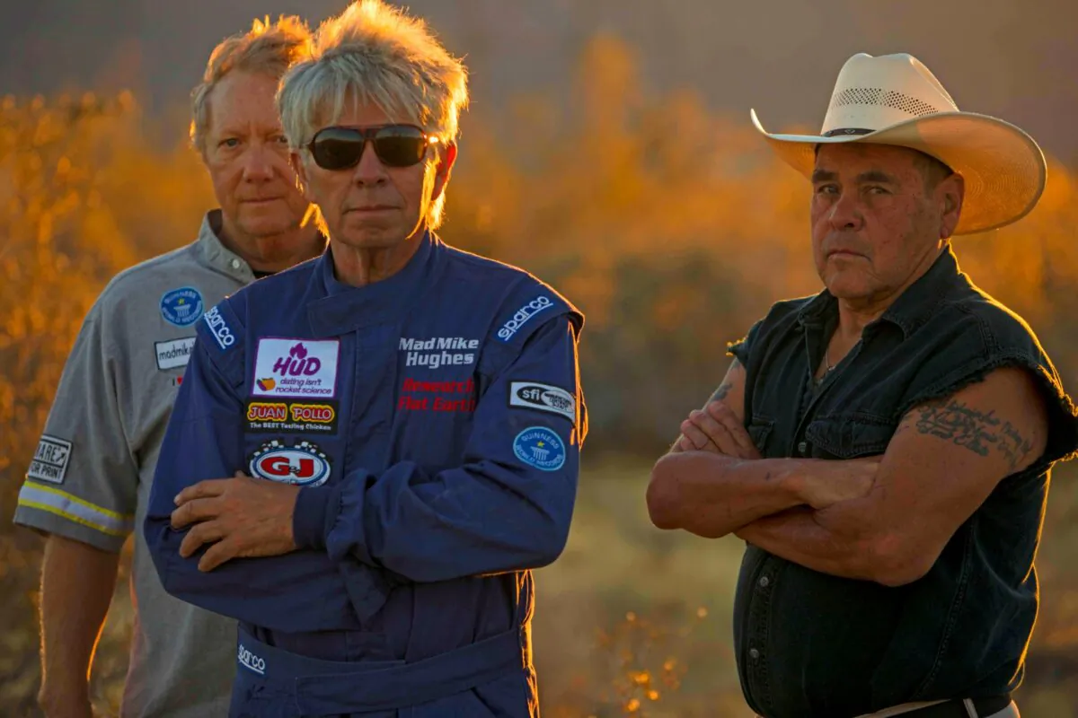 The late daredevil "Mad" Mike Hughes (C) stands with friends and collaborators, Waldo Stakes (R) and Patrick Marchese (L), ahead of one of many launches Hughes made in homemade rockets, this one in Amboy, Calif., on March 24, 2018. (Toby Brusseau)