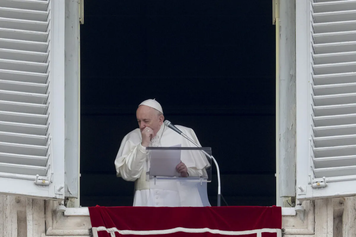 Pope Francis coughs during the Angelus noon prayer he recited from the window of his studio overlooking St. Peter’s Square, at the Vatican, on March 1, 2020. (Andrew Medichini/AP Photo)