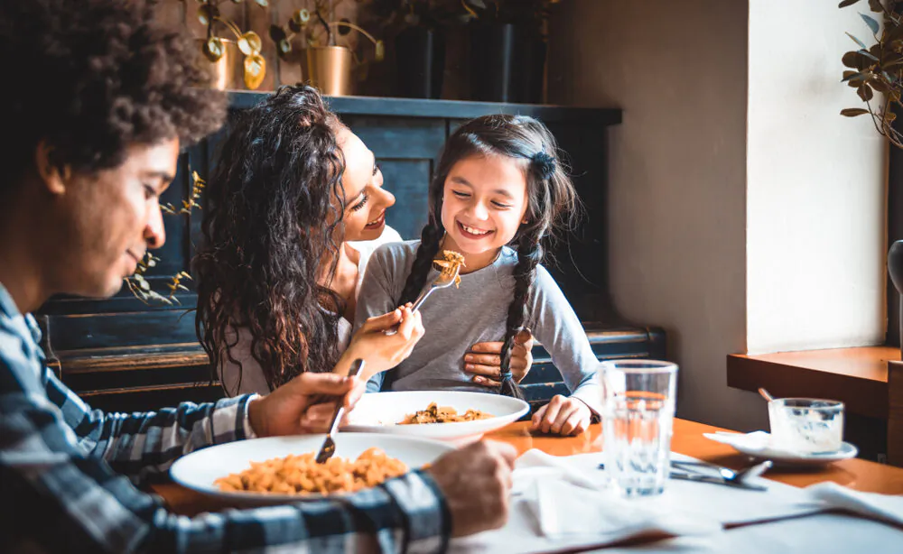 Dining out as a family can be a rewarding bonding experience. (Leszek Glasner/Shutterstock)