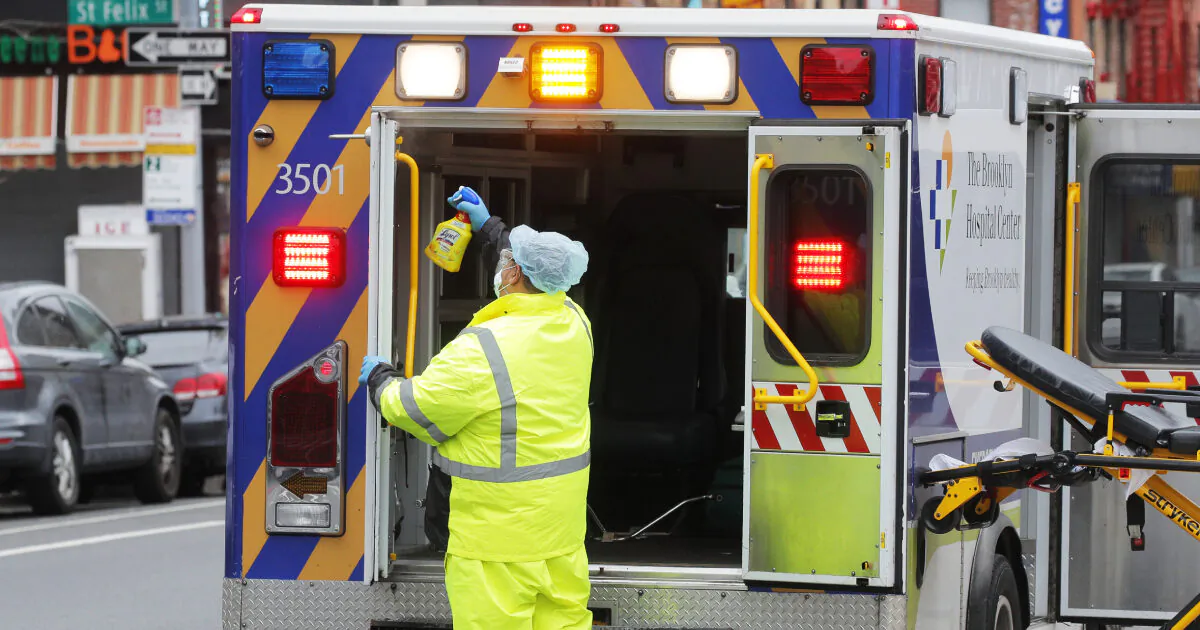 An ambulance worker sprays disinfectant inside an ambulance outside The Brooklyn Hospital Center during the CCP virus outbreak in the Brooklyn borough of New York City, New York, U.S., March 31, 2020. (Brendan Mcdermid/Reuters)