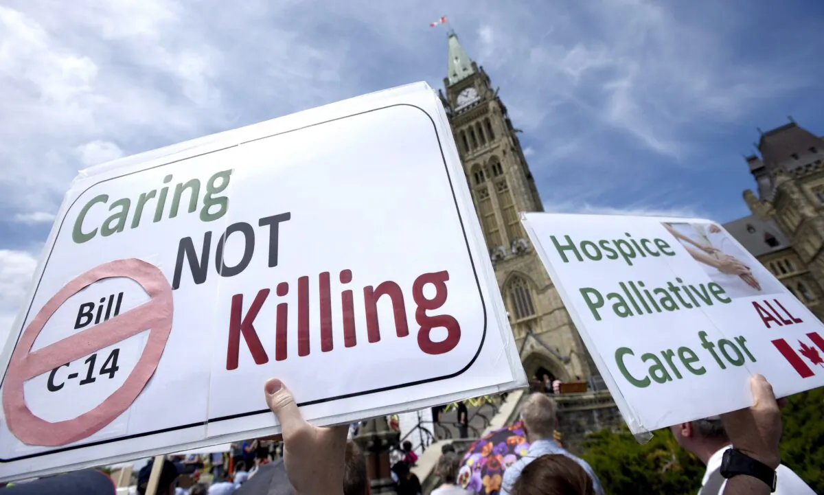 People protest against Bill C-14, the medically assisted dying bill, during a rally on Parliament Hill on June 1, 2016. The federal government has now tabled legislation to expand the availability of assisted suicide. (The Canadian Press/Justin Tang)