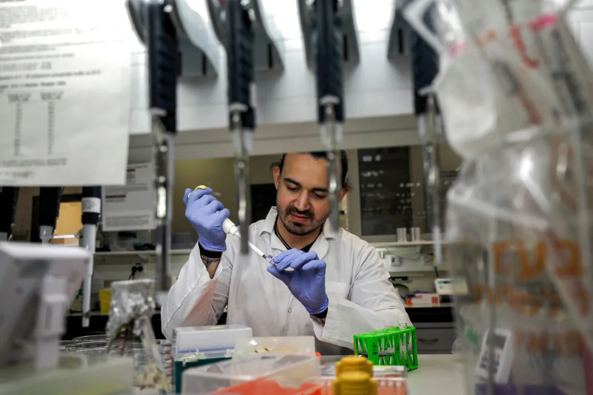 An Israeli scientist works at a laboratory at the MIGAL Research Institute in Kiryat Shmona in the upper Galilee in northern Israel, where efforts are underway to produce a vaccine against the coronavirus adapted from another for infectious bronchitis virus, on March 1, 2020. (Jalaa Marey/AFP via Getty Images)