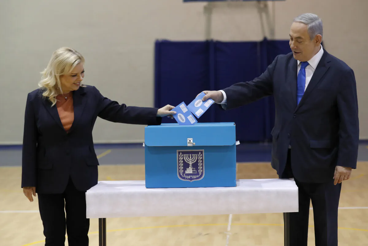 Israeli Prime Minister Benjamin Netanyahu, (R), and his wife Sara Netanyahu cast their ballots during the Israeli legislative elections at a polling station in Jerusalem, Israel, on March 2, 2020. (Atef Safadi/Pool Photo via AP)