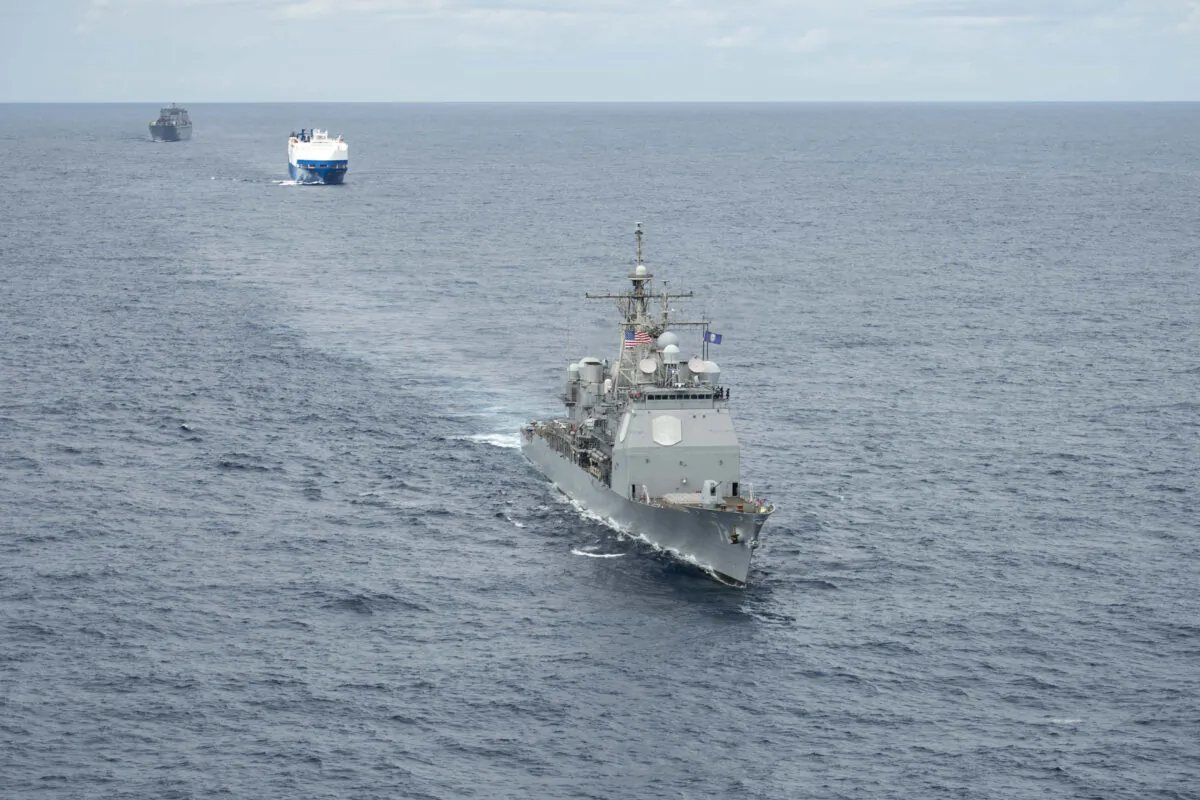 A convoy comprised of the Ticonderoga-class guided-missile cruiser USS Vella Gulf (CG 72) (R), the vehicle carrier MV Resolve (C), and the Military Sea Lift Command (MSC) roll-on roll-off cargo ship USNS Benavidez (T-AKR 306) steam in formation. (U.S. Navy Photo by Mass Communication Specialist 3rd Class Andrew Waters/Released)