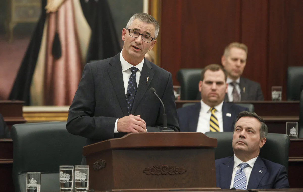 Alberta Finance Minister Travis Toews (L), delivers the budget as Alberta Premier Jason Kenney watches in Edmonton on Feb. 27, 2020. (The Canadian Press/Jason Franson)