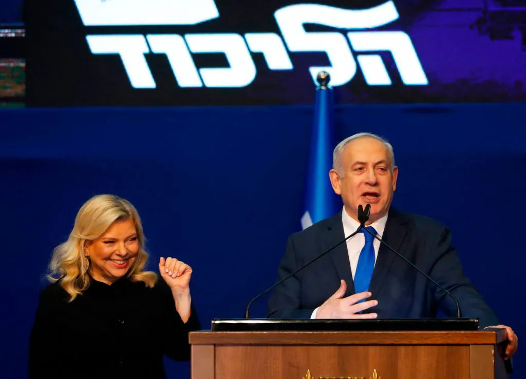Israeli Prime Minister Benjamin Netanyahu addresses supporters, as his wife, Sara, looks on, at the Likud party campaign headquarters in the coastal city of Tel Aviv, Israel, on March 3, 2020.  JACK GUEZ/AFP via Getty Images