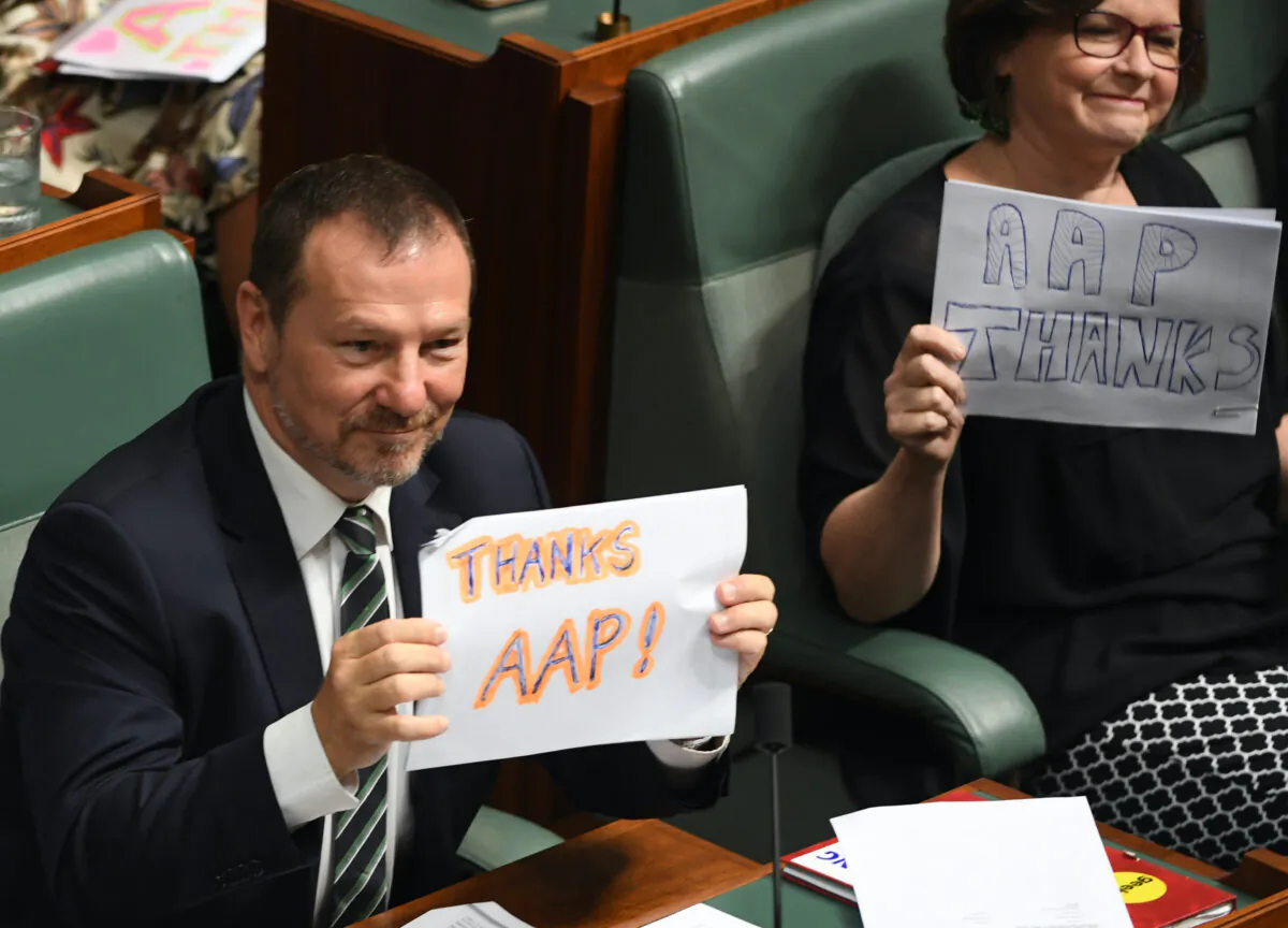 The Australian Associated Press has announced it will be shutting down after 85 years. Labor ministers hold up 'Thanks AAP' signs during Question Time in the House of Representatives in Canberra, Australia on March 03, 2020. (Tracey Nearmy/Getty Images)