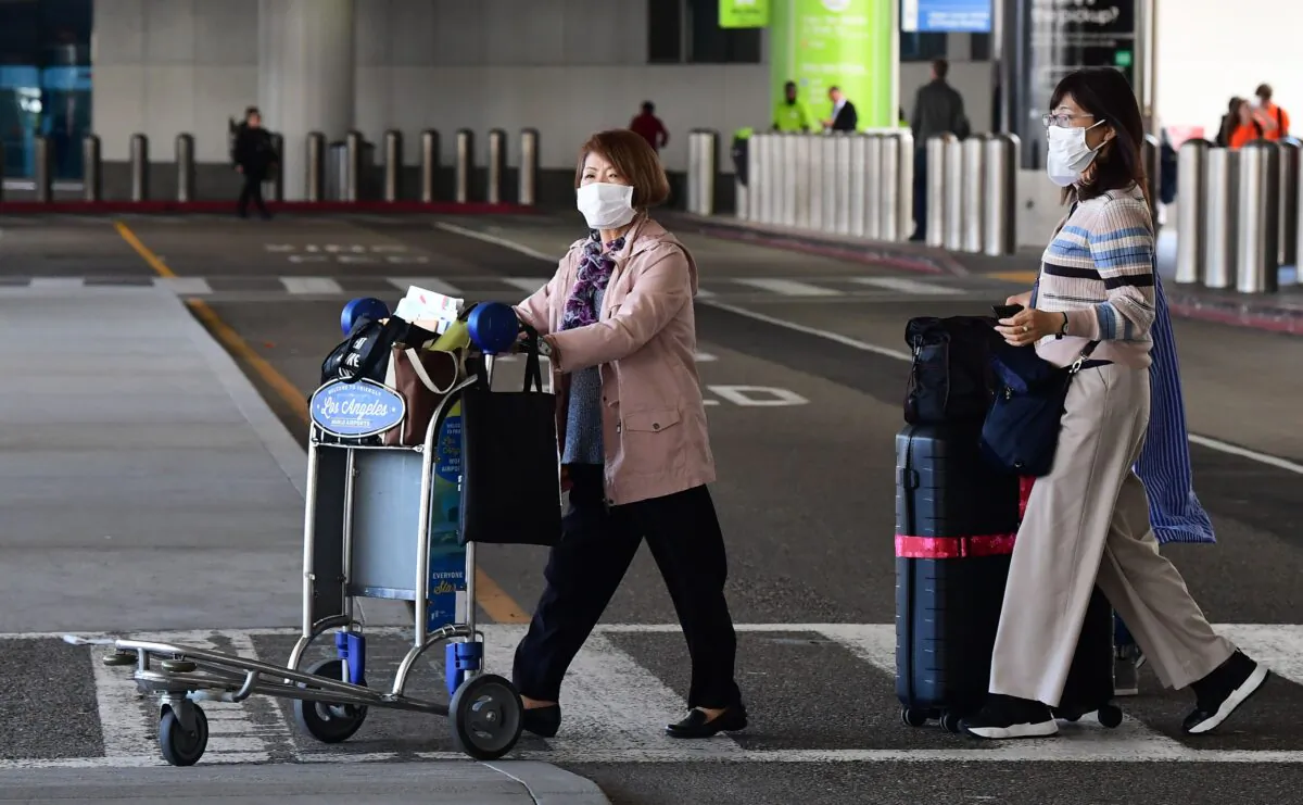 Women wear face masks at Los Angeles International Airport in California on March 2, 2020. (Frederic J. Brown/AFP via Getty Images)