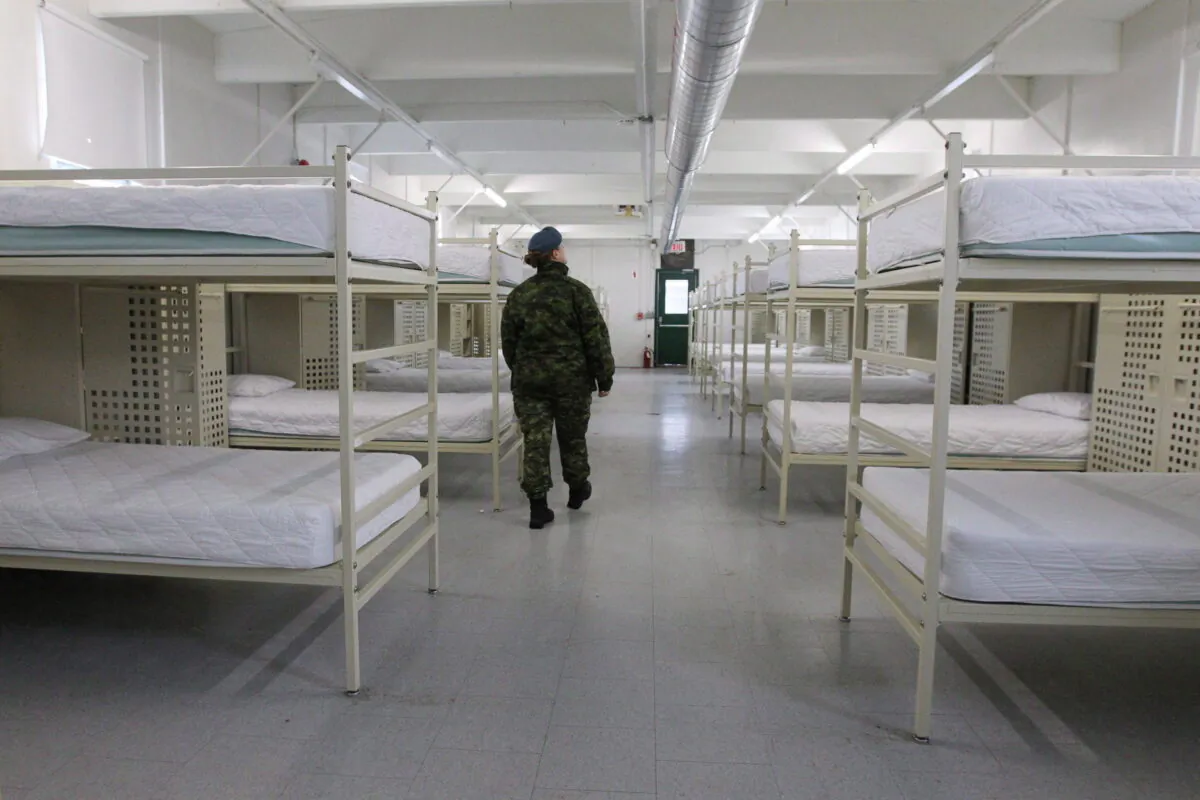 A member of the Canadian Armed Forces walks inside one of the barracks at CFB Trenton in Trenton, Ont., on December 1, 2015. (THE CANADIAN PRESS/Lars Hagberg)