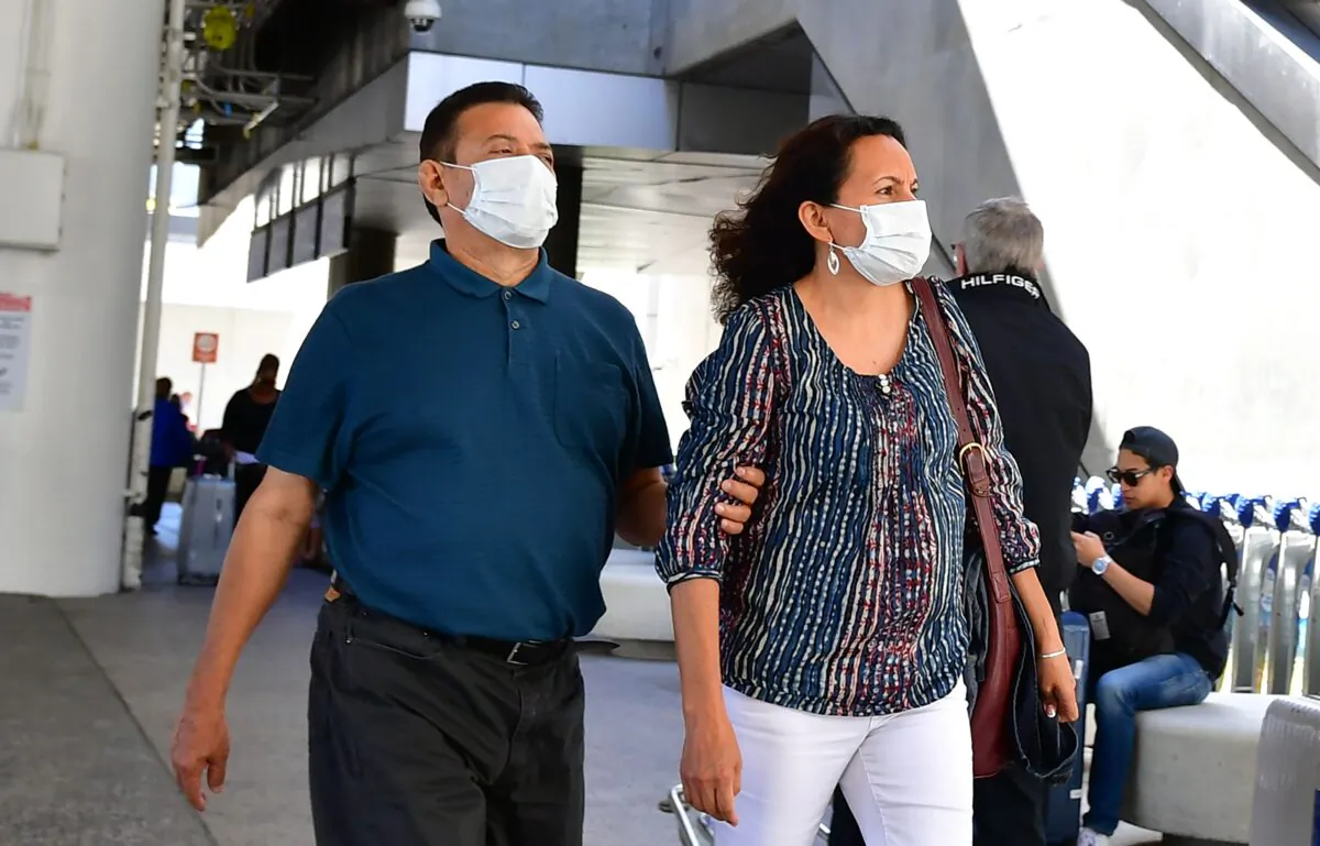 People wear face masks at Los Angeles International Airport (LAX) in Los Angeles, Calif., on March 2, 2020. (Frederic J. Brown/AFP via Getty Images)