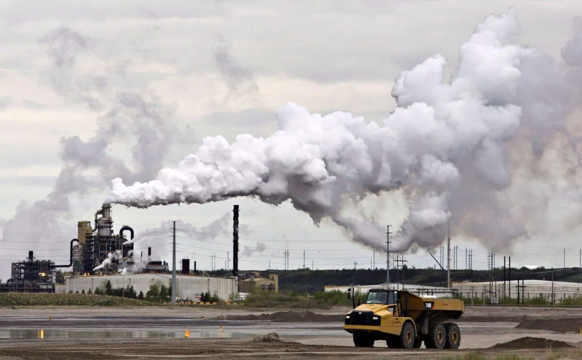 A dump truck works near the Syncrude oilsands extraction facility near Fort McMurray, Alberta, in a file photo. (The Canadian Press/Jason Franson)