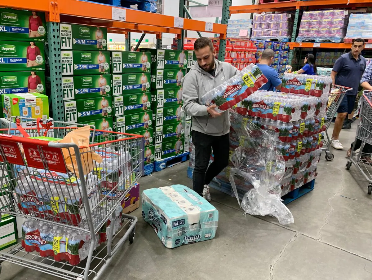 A man buys water, food, and toilet paper at a store in Los Angeles on Feb. 29, 2020. (Mark Ralston/AFP via Getty Images)