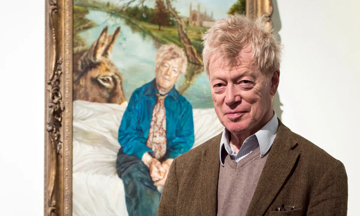 The late Sir Roger Scruton poses next to his portrait painted by the artist Lantian D at the Royal Society of Portrait Painters Photocall at the Mall Galleries in London, England, on May 4, 2016. (Ian Gavan/Getty Images)