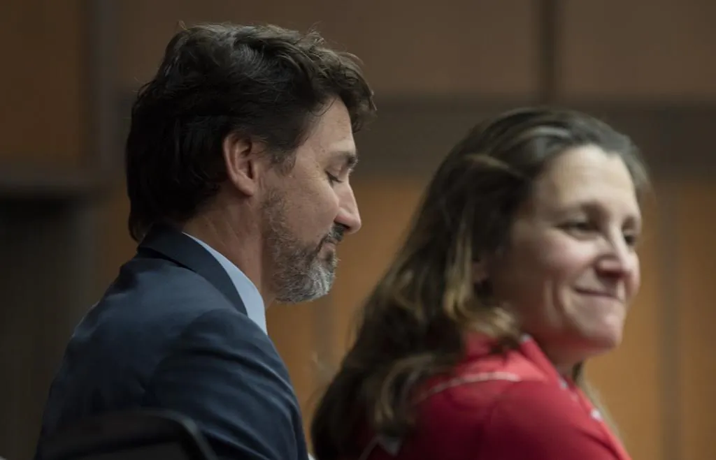 Prime Minister Justin Trudeau sits beside Deputy Prime Minister and Minister of Intergovernmental Affairs Chrystia Freeland before speaking to members of caucus on Parliament Hill in Ottawa, on Jan. 23, 2020. (Adrian Wyld/The Canadian Press)