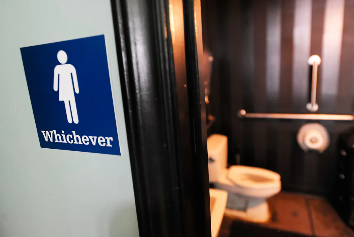 A gender neutral sign is posted outside a bathrooms at Oval Park Grill in Durham, N.C., on May 11, 2016. (Sara D. Davis/Getty Images)