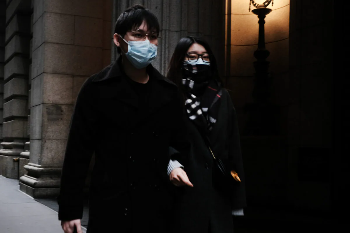 A couple in medical masks walk through the financial district in Manhattan in New York City on March 3, 2020. (Spencer Platt/Getty Images)