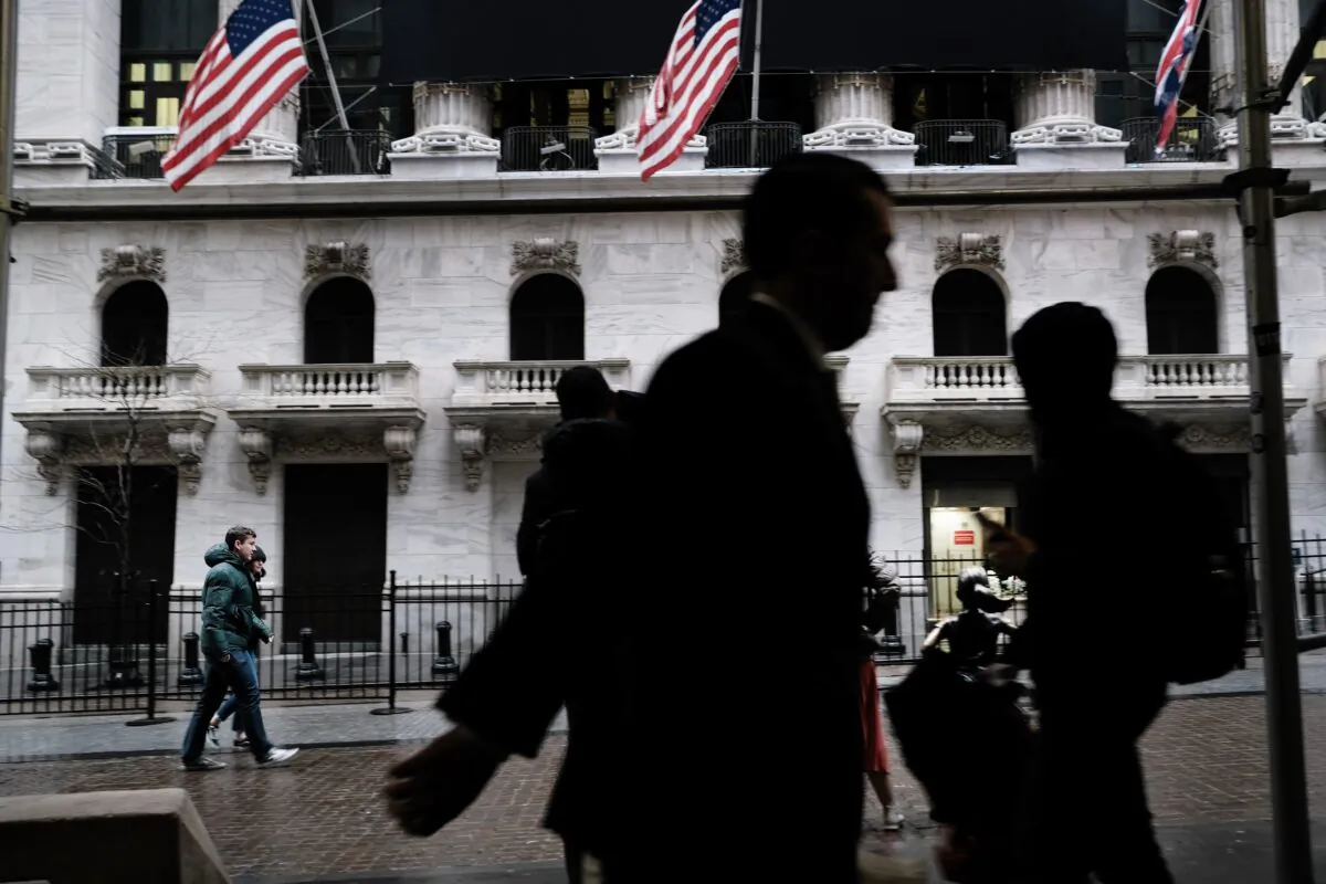 People walk by the New York Stock Exchange in New York City on March 3, 2020. (Spencer Platt/Getty Images)