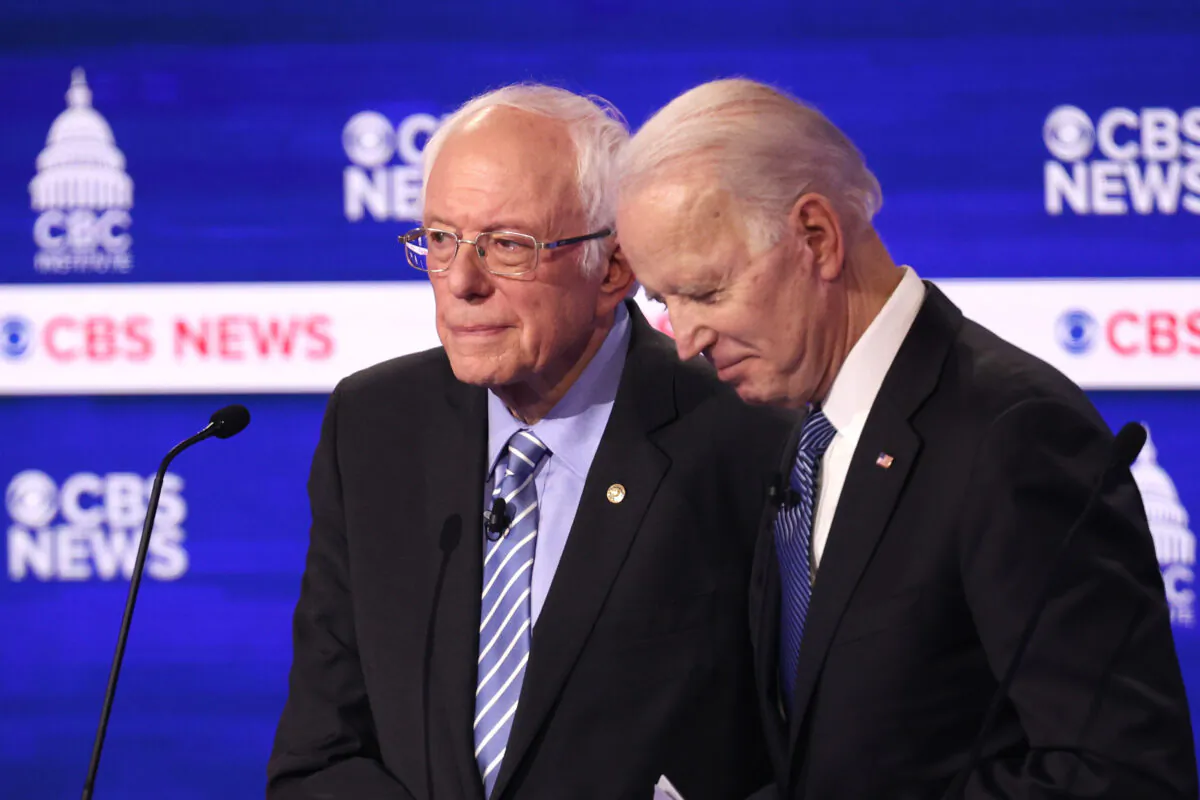 Democratic presidential candidates Sen. Bernie Sanders (I-Vt.) and former Vice President Joe Biden speak during a break at the Democratic presidential primary debate at the Charleston Gaillard Center n Charleston, S.C., on Feb. 25, 2020. (Win McNamee/Getty Images)