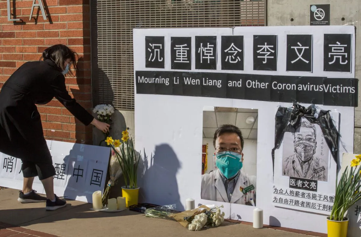 Chinese students and their supporters hold a memorial for Dr Li Wenliang, who was the whistleblower of the coronavirus that originated in Wuhan, China, and caused the doctor's death in that city, outside the UCLA campus in Westwood, Calif., on Feb. 15, 2020. (MARK RALSTON/AFP via Getty Images)