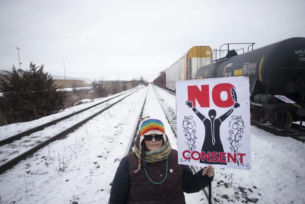 A protester holds a placard as supporters of the Wet'suwet'en hereditary chiefs demonstrate at Macmillan Yard in Toronto, on Feb. 15, 2020.Chris Young / The Canadian Press)