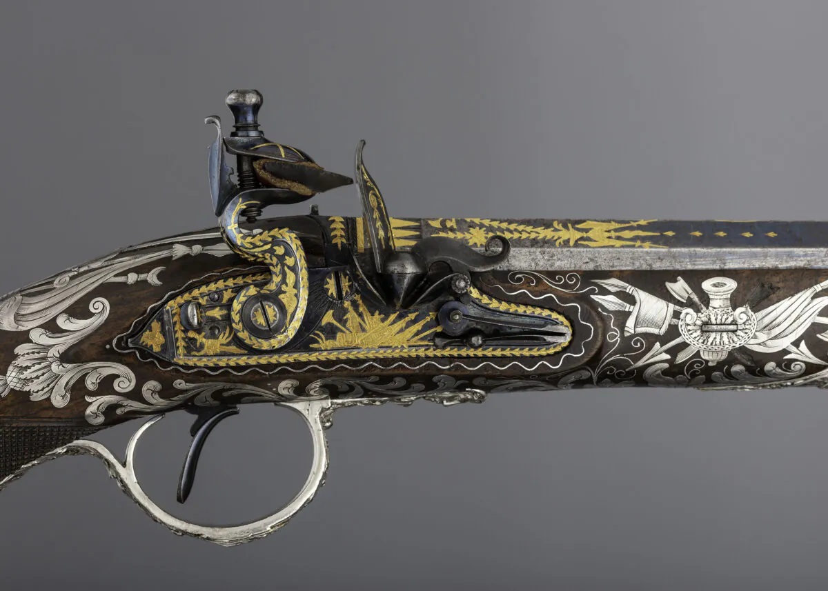 Detail of the flintlock pistol's blued steel lock and barrel engraved and gold-inlaid with trophies of arms and foliage; 1800–1801, by gunmaker Samuel Brunn and silversmith Michael Barnet. British, London. Purchased through the Harris Brisbane Dick Fund and gift of George D. Pratt, by exchange, 1992. (The Metropolitan Museum of Art)