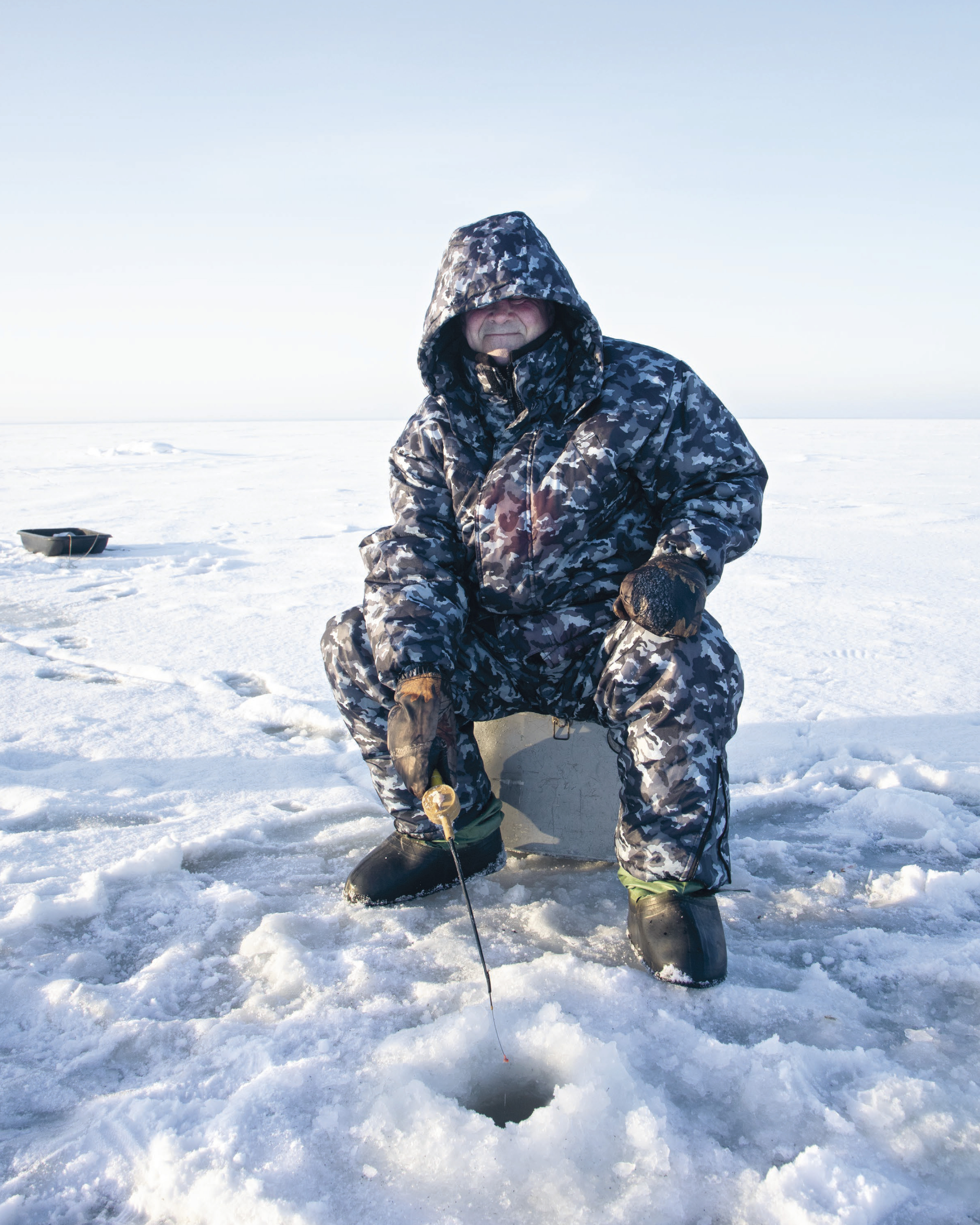 russian man ice fishing