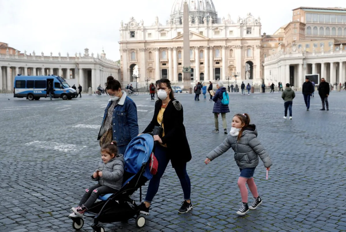 People wear protective face masks on St. Peter's Square after the Vatican reports its first case of coronavirus, at the Vatican, on March 6, 2020. (Remo Casilli/Reuters)