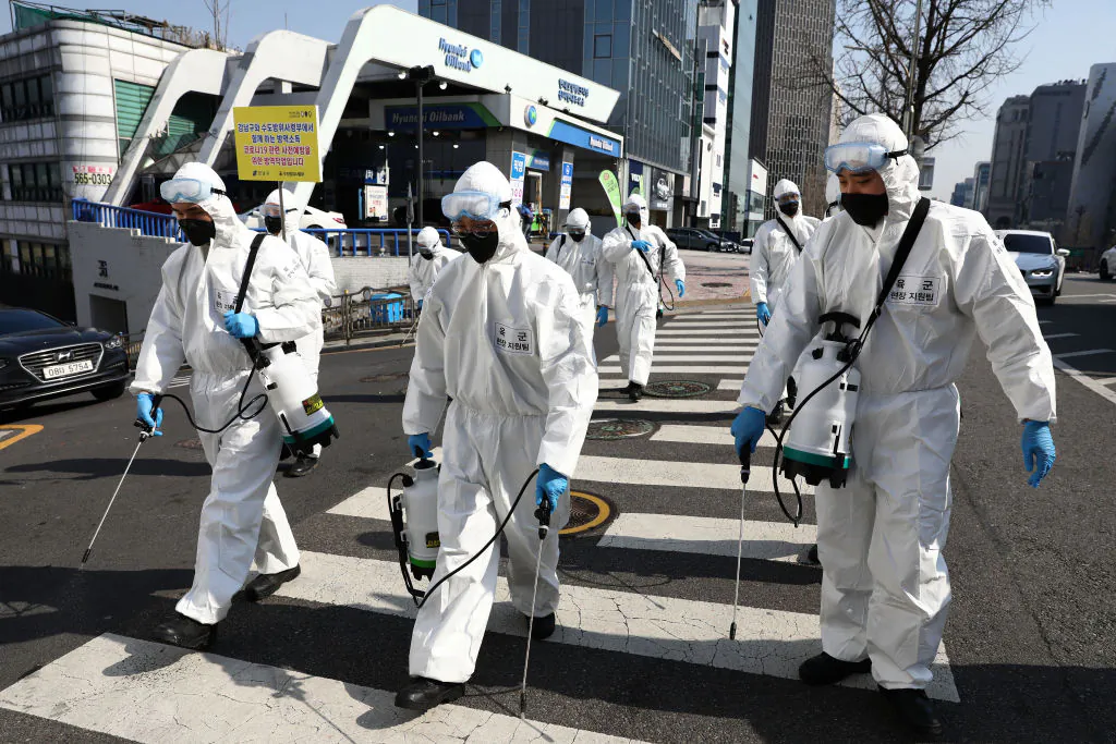 South Korean soldiers wearing protective gear spray antiseptic solution against the novel coronavirus in Gangnam district in Seoul, South Korea, on March 6, 2020. (Chung Sung-Jun/Getty Images)