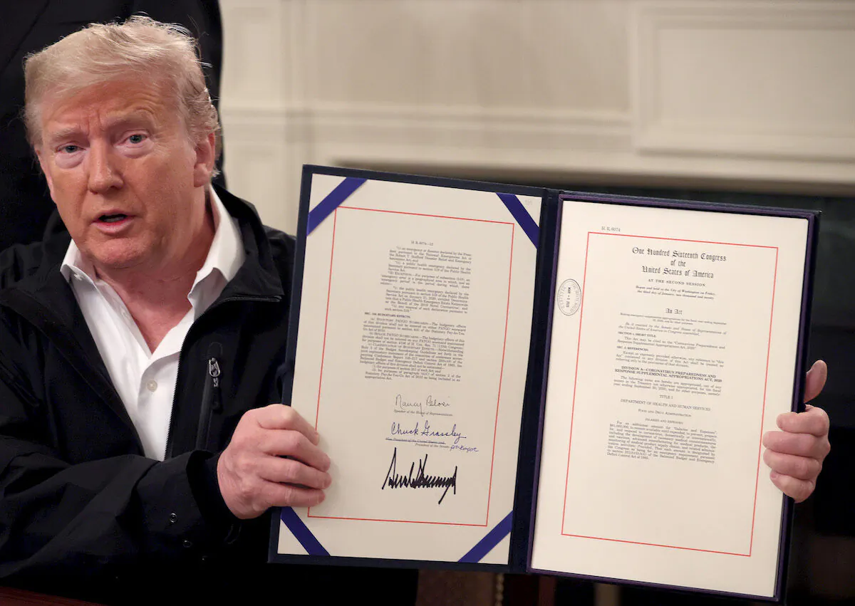 President Donald Trump shows off a bipartisan $8 billion funding bill he signed at the White House to combat the coronavirus outbreak on March 6, 2020. (Win McNamee/Getty Images)