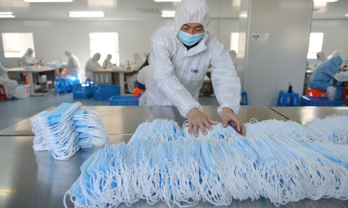 A worker at a factory in Nanjing in China's Jiangsu provincee is sorting face masks on Feb. 18, 2020. (STR/AFP via Getty Images)