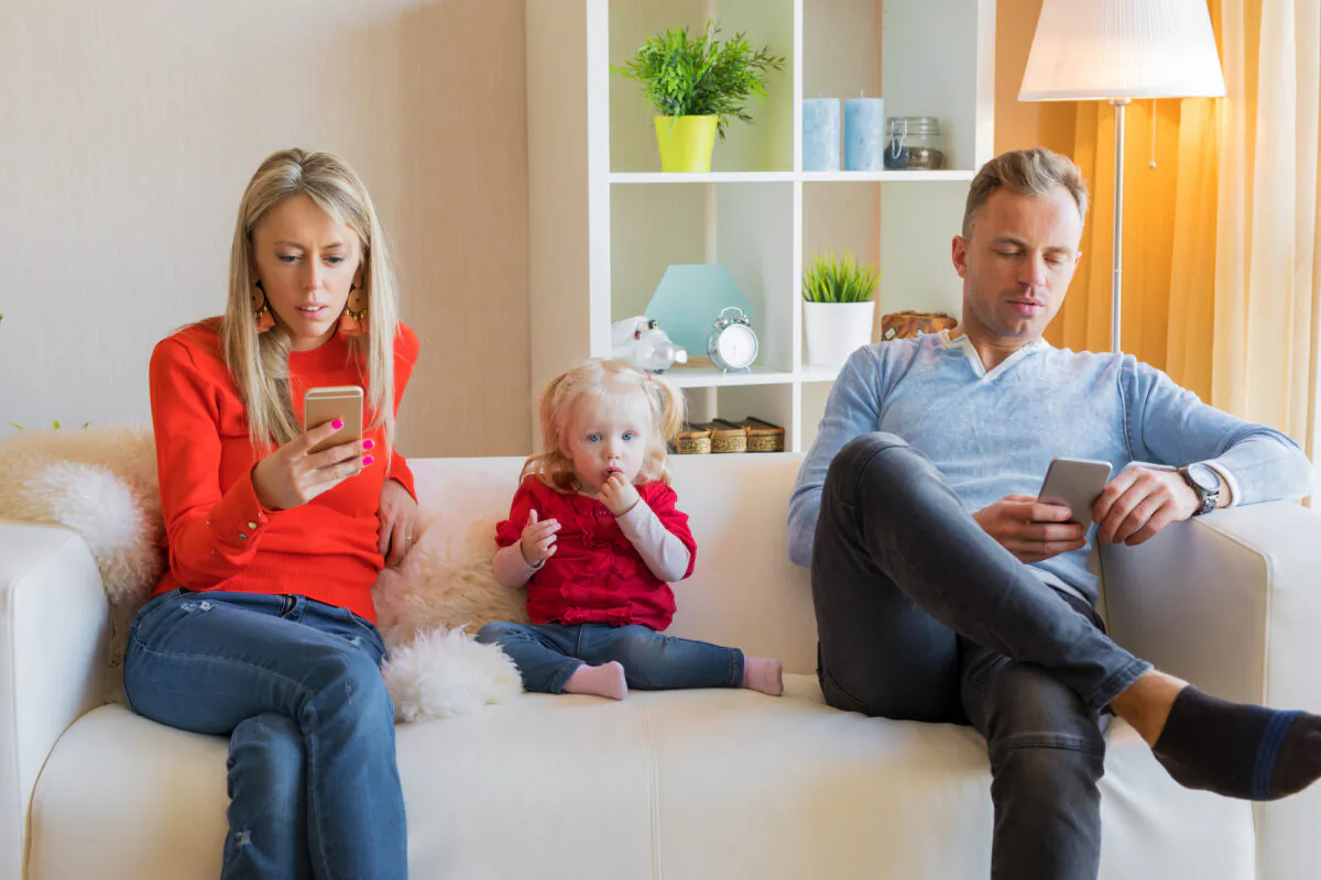 Children learn and develop their behavior by watching others, especially their parents, and this includes screen use. (Kaspars Grinvalds/Shutterstock)