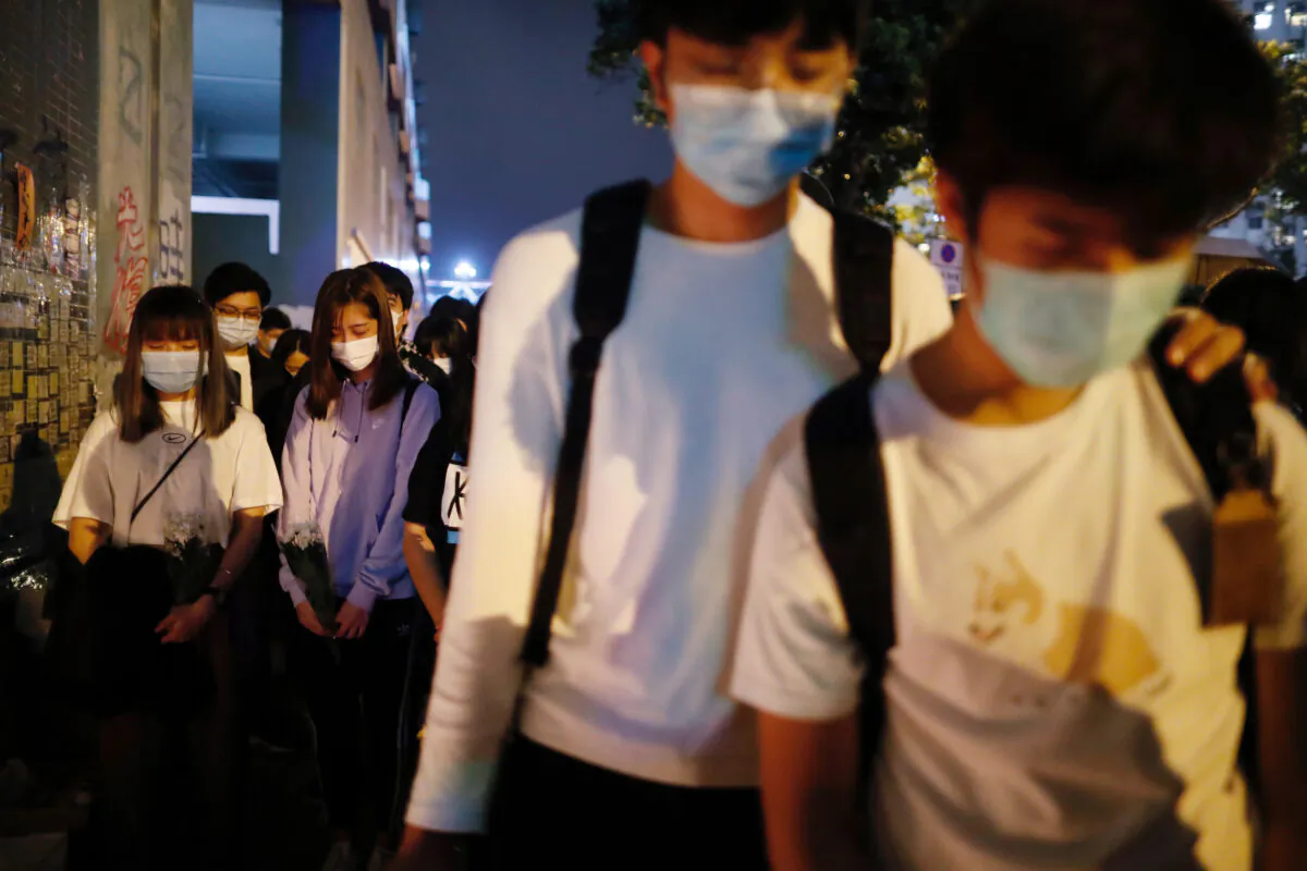 Protesters attend a vigil to mourn the anniversary of a student protester's death, in Hong Kong, on March 8, 2020. (REUTERS/Tyrone Siu)