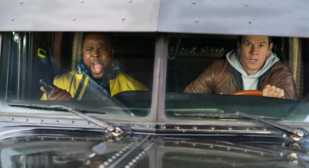 Winston Duke (L) and Mark Wahlberg star as a team to bring down the bad guys, in “Spenser Confidential.” (Netflix)