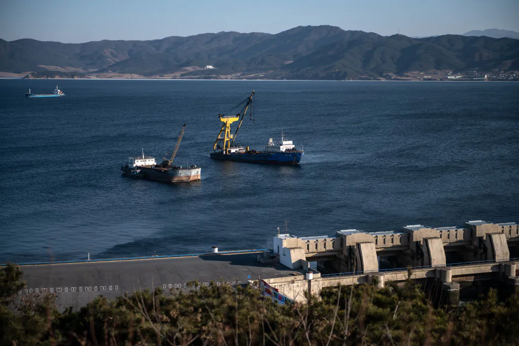 Ships are moored next to the 8-kilometer-long West Sea Barrage, a system of dams, lock chambers, and sluices that close off the Taedong River from the Yellow Sea, in Nampo, North Korea, on Feb. 7, 2019. (Carl Court/Getty Images)